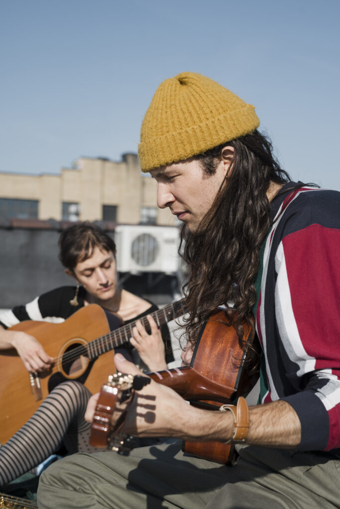 man and women playing instruments assisted by a support worker