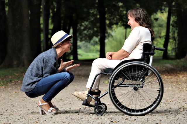 A support worker with a lady in a wheelchair on a Short Term Accommodation adventure